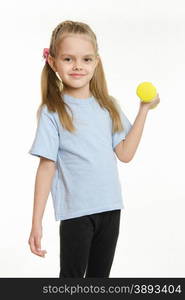 Six year old girl Europeans engaged in physical exercises. Six year old girl engaged in lifting a dumbbell exercise