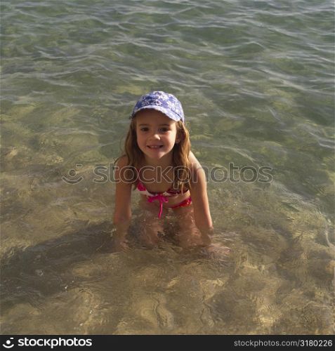 Six year old girl playing in the water