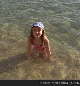 Six year old girl playing in the water