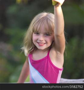 Six year old with her arm raised