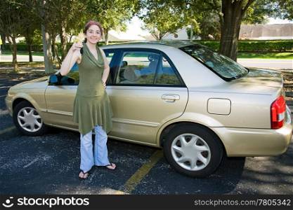 Sixteen year old girl holding the keys to her first car.