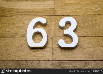 Sixty-three figures on a wooden, parquet floor as a background.. Sixty-three figures on a wooden parquet floor.