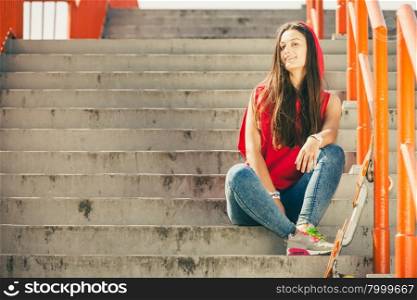 Skate girl on stairs with skateboard.. Cool skater young long haired girl with skateboard sitting on the urban stairs. Active lifestyle funky in summer. Outdoor trendy sport teenage.