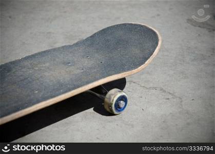 Skateboard front, selective focus on nose grip texture.