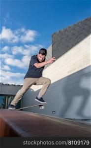 Skateboarder doing a nose slide trick  on a urban scene.