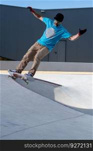 Skateboarder doing frontside five-o grind trick in concrete skatepark.