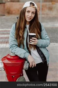 skateboarder girl holding cup coffee
