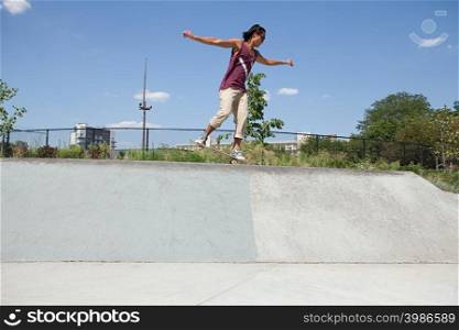 Skateboarder on ramp at skate park