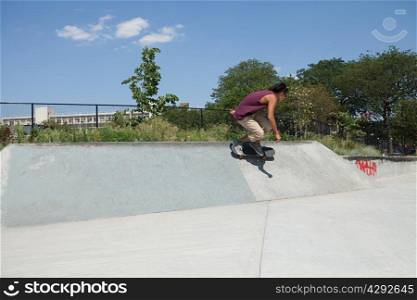 Skateboarder on ramp at skate park