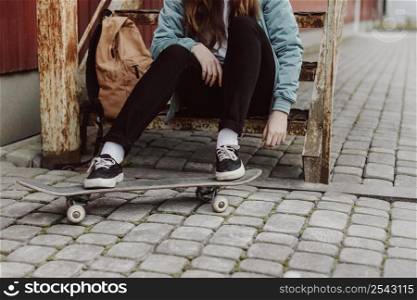 skater girl urban sitting stairs front view