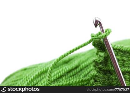 Skein of wool, crochet hook and knitted piece isolated on white