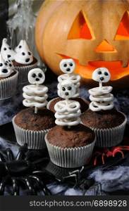 skeleton of pretzels in milk chocolate and marshmallow in a muffin, on a table in honor of Halloween