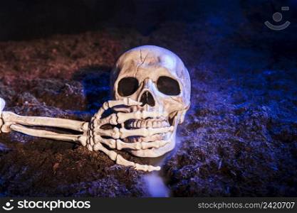 skeleton s hand closing skull s tooth ground