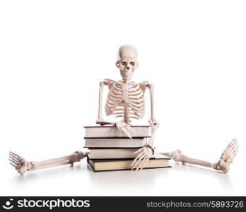 Skeleton with books isolated on white