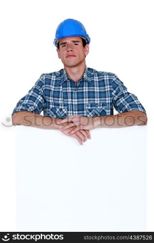 Skeptical workman with a blank board