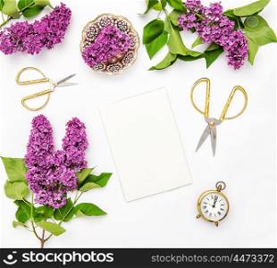 Sketchbook, lilac flowers, office tools and accessories. Flat lay notebook, top view