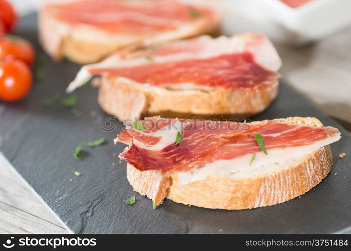 Skewer iberico ham with his bread with tomato