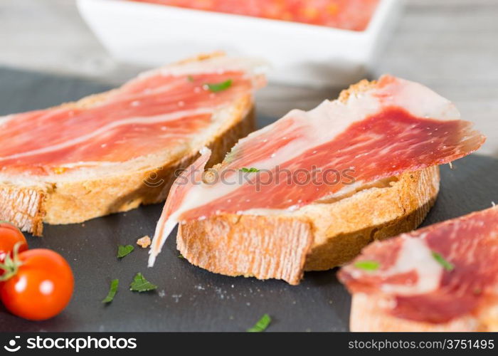 Skewer iberico ham with his bread with tomato