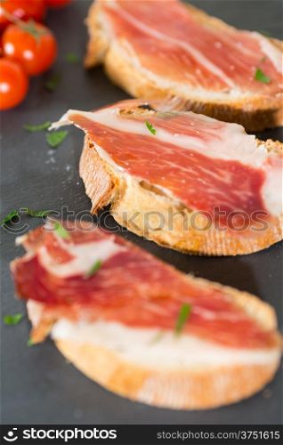 Skewer iberico ham with his bread with tomato