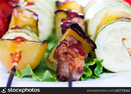 skewers of meat and various fresh vegetables