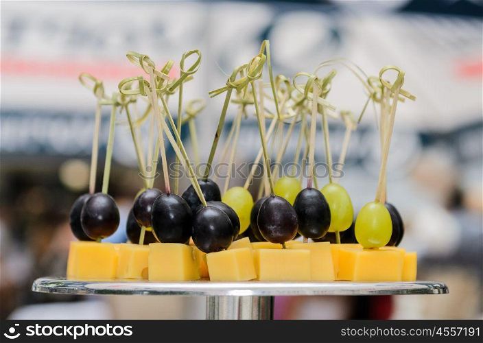 skewers with grapes and cheese on the stand at the Banquet