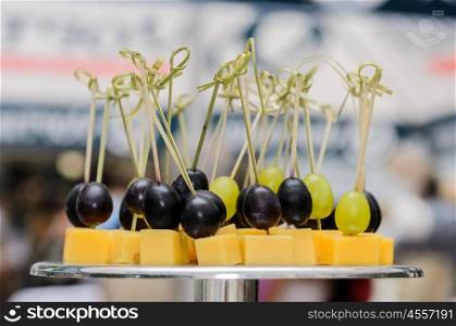 skewers with grapes and cheese on the stand at the Banquet