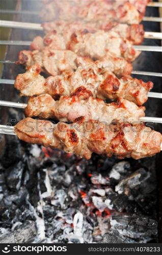 skewers with meat shish kebabs over burning coal close up