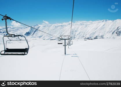 Ski lift chairs on bright winter day