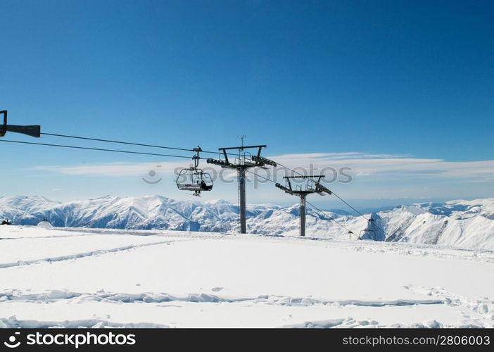 Ski lift chairs on bright winter day