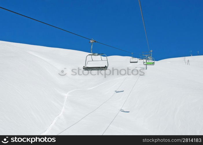 Ski lift chairs on bright winter day