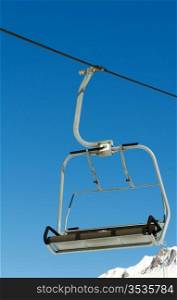 Ski lift chairs on bright winter day