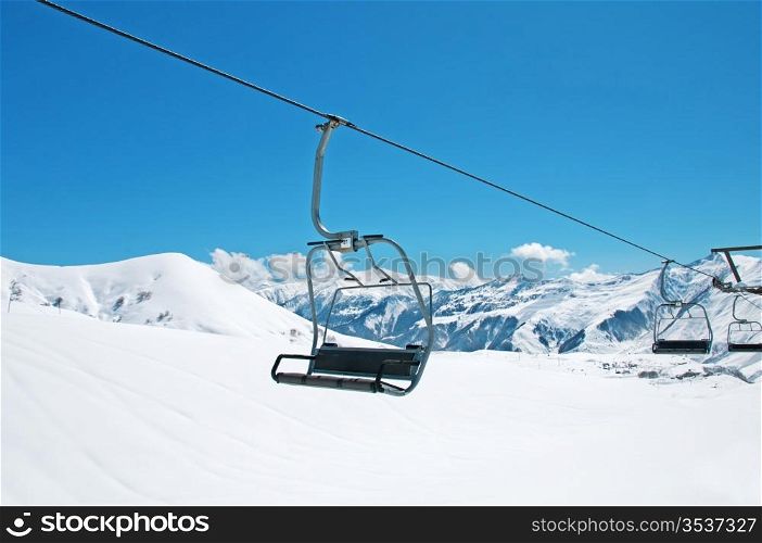 Ski lift chairs on bright winter day