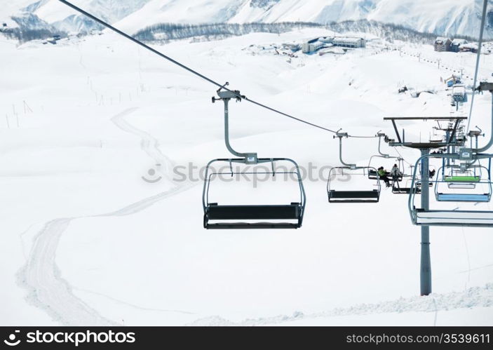 Ski lift chairs on bright winter day