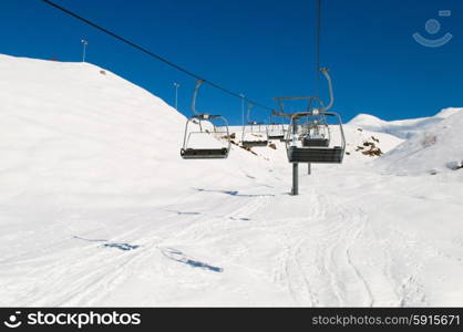 Ski lift chairs on bright winter day&#xA;