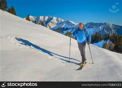 Ski mountaineering man climbing alone in training in the Alps