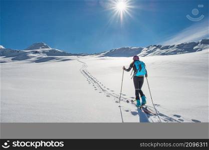 Ski mountaineering track slightly uphill with a skirt following it