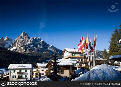 Ski Resort In Italian Alps. Flags Against Winter Landscape.