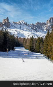 Ski slope called Cigolade in Vigo di Fassa, Italian Dolomites in South Tyrol with flat slopes and under blue sky. Cigolade ski slope in Vigo di Fassa