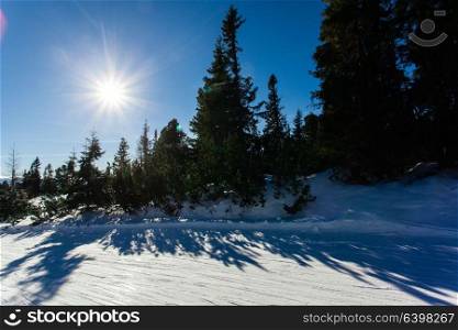 Ski slope in High Tatras mountains. Frosty sunny day. Ski slope landscape