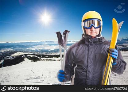 Ski slope in High Tatras mountains on the background and skier portait with equipment. Ski slope and skier