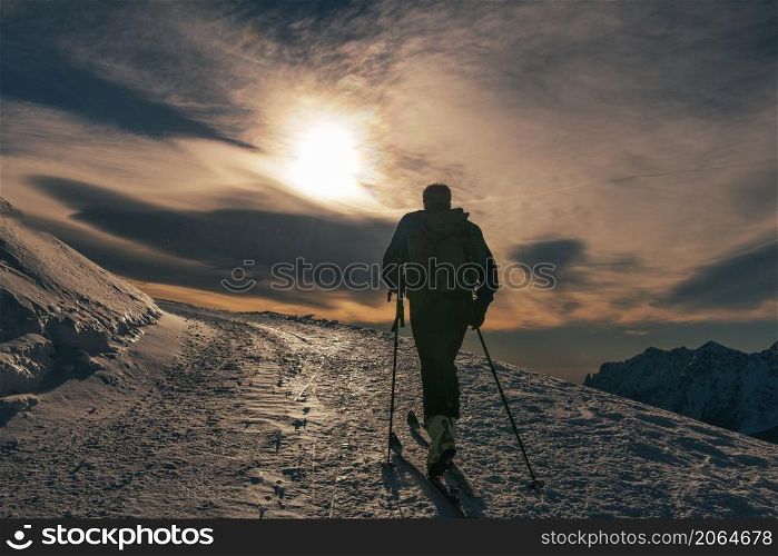 Ski tourism on snow road on italian alps