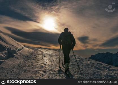Ski tourism on snow road on italian alps