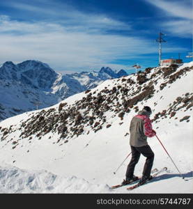 Skier at ski resort. Snow in the mountains