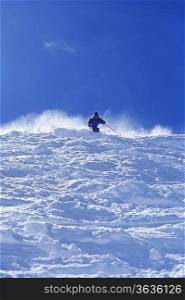 Skier Descending Steep Snowy Slope