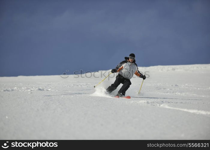 skier free ride downhill at winter season on beautiful sunny day