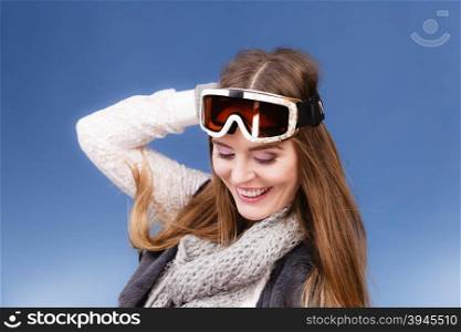 skier girl wearing warm clothes ski googles portrait. . Woman skier girl wearing warm clothing ski googles portrait. Winter sport activity. Beautiful sportswoman on blue studio shot