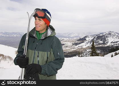 Skier Holding Skis on Mountain