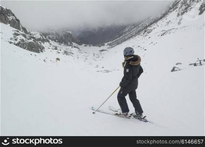 Skier in snow covered valley, Whistler Blackcomb, Vancouver, British Columbia, Canada