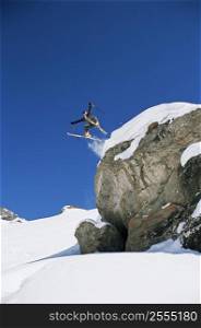 Skier jumping off cliff (far away)