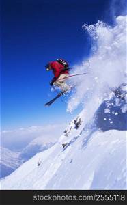 Skier jumping on snowy hill